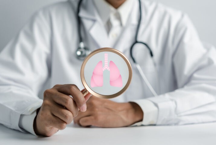 Doctor holding Magnifier focus to lungs icon, world tuberculosis day or world no tobacco day, lung cancer care concept copd, eco air pollution, donation lung organ