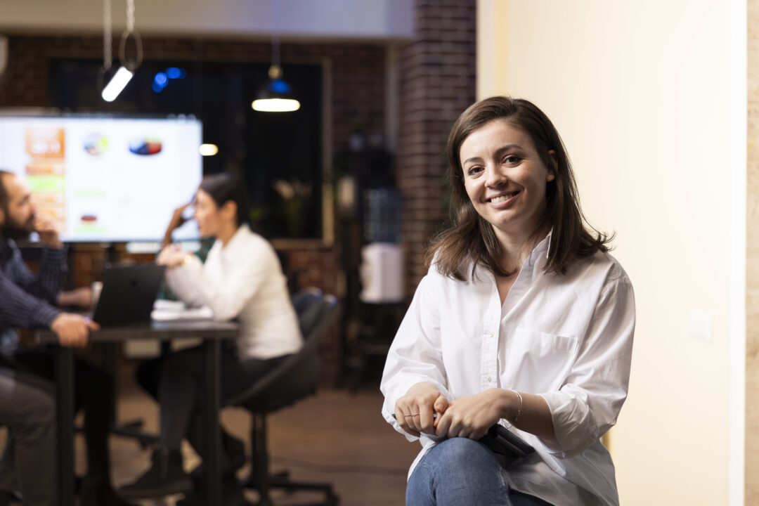 Caucasian businesswoman holding tablet at work