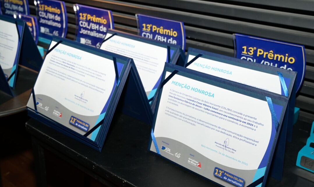 Troféus e certificados do Prêmio CDL/BH de Jornalismo organizados em mesa durante premiação em Belo Horizonte