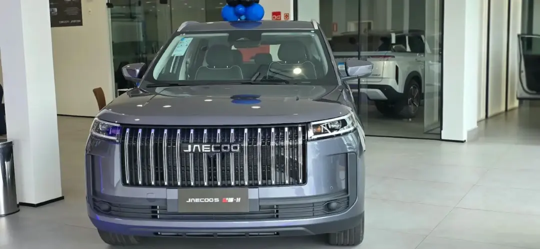 Jaecoo 5 híbrido chega às lojas do Grupo Carbel em Minas Gerais SUV Jaecoo 5 cinza exposto de frente no showroom de uma concessionária, com o logotipo da marca na grade dianteira